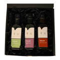 Würzöl-Geschenkset von Kraut & Korn mit drei 100-ml-Flaschen in offener schwarzer Geschenkbox